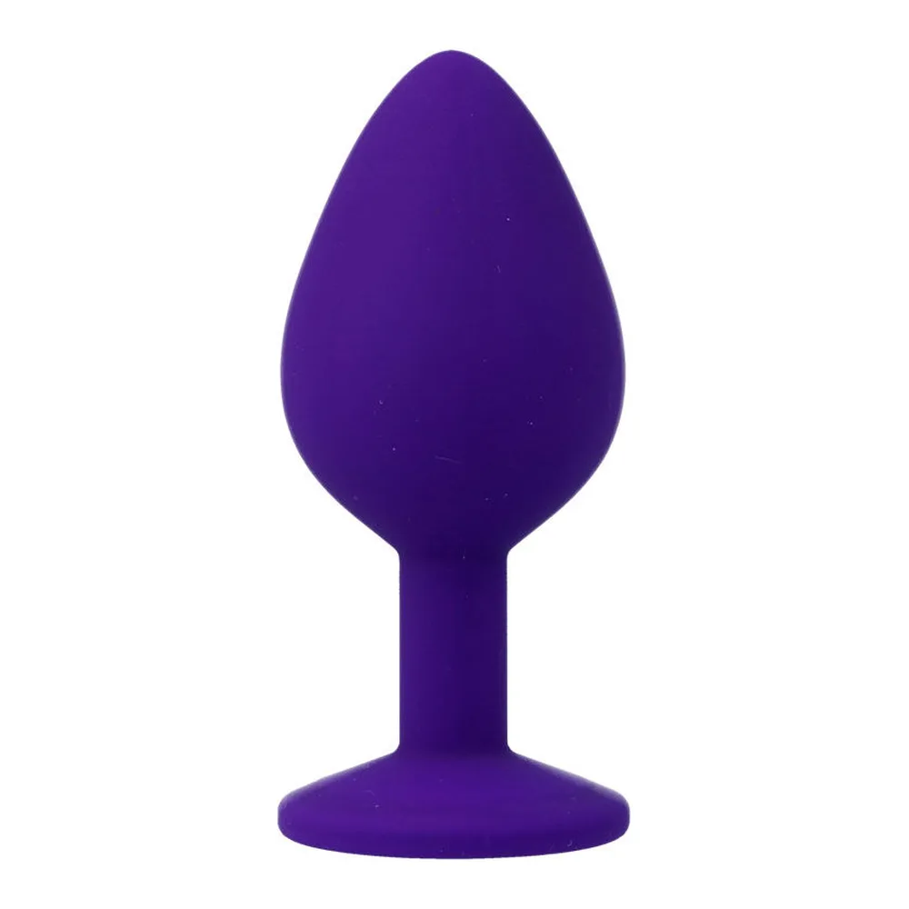 Plug anal en silicone noir avec base évasée, orné d'un cristal transparent facetté sur l'extrémité arrondie, fond blanc