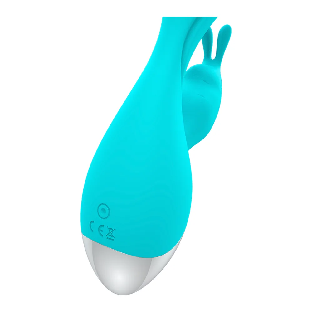 Vibromasseur rabbit en silicone turquoise avec bras de stimulation, base argentée à picots et palpeur rose vif, fond blanc