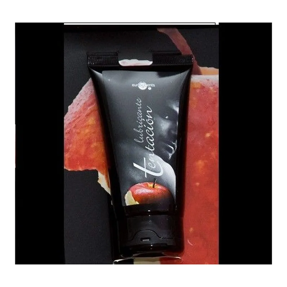 Tube noir de lubrifiant comestible à saveur coco avec bouchon noir, étiquette affichant un profil de visage et une pomme rouge sur fond dégradé gris et noir