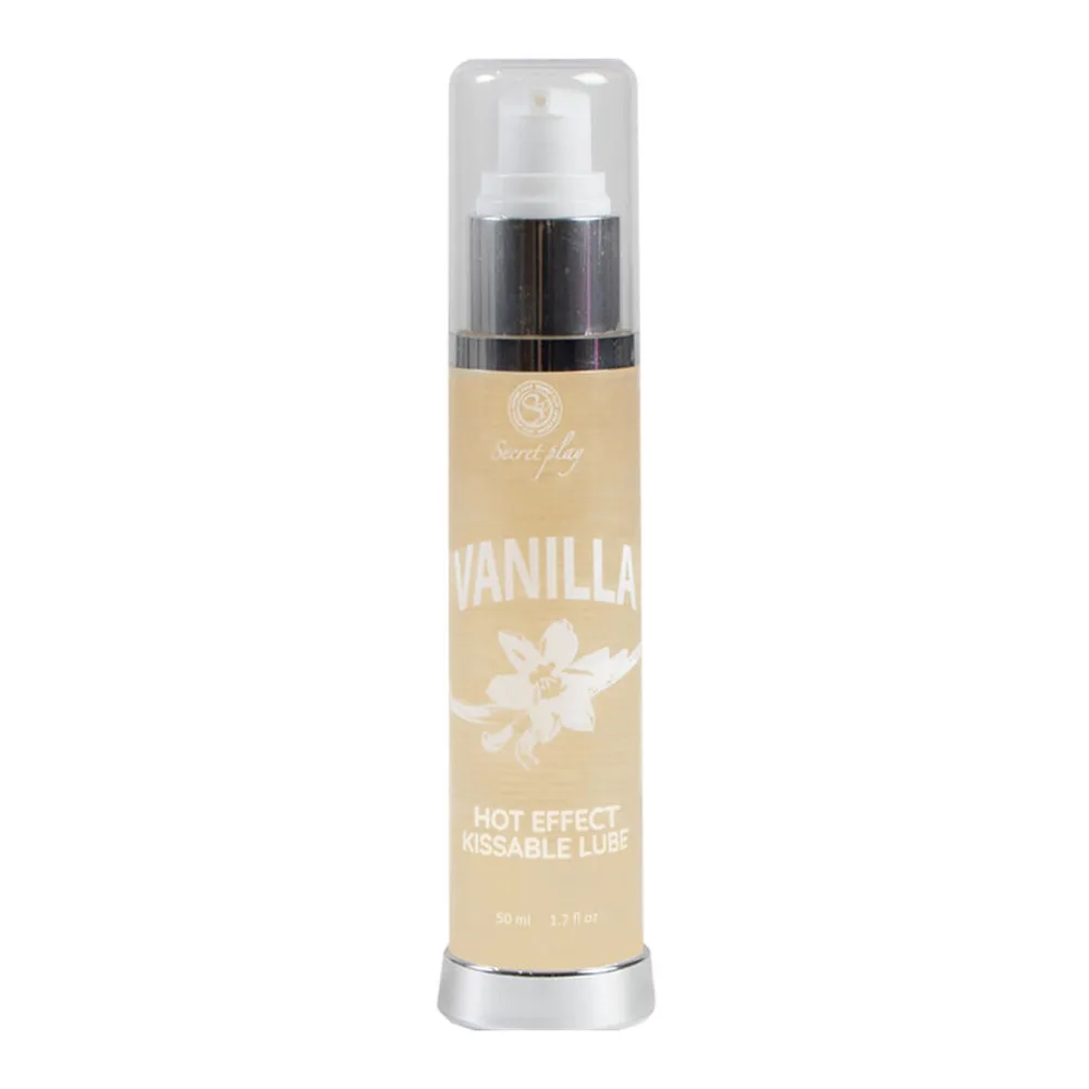 Flacon spray de lubrifiant vanille à effet chaleur, tenu en main, avec étiquette beige et bande noire, sur fond blanc