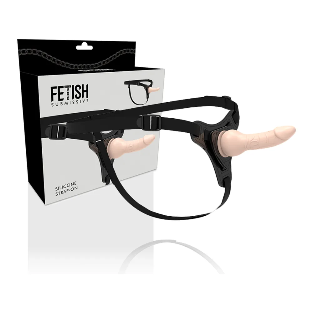 Ensemble strap-on Fetish Submission avec harnais noir ajustable et gode en silicone couleur chair, présenté avec son emballage