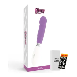 Emballage du vibrateur Paul en carton blanc et violet, avec le produit en silicone violet et blanc à côté, et deux piles AAA incluses