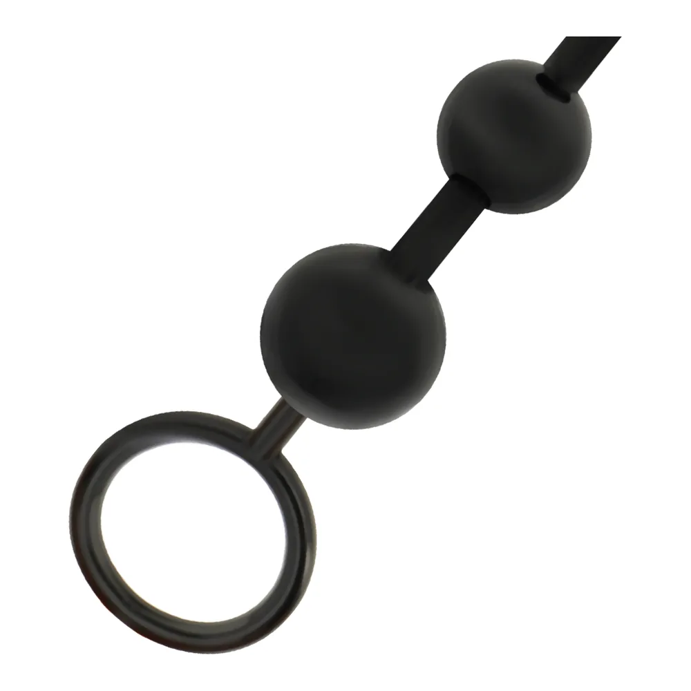 Chaîne de billes anales noire avec anneau, composée de deux sphères graduées reliées par une tige flexible, terminée par un anneau de retrait sur fond blanc