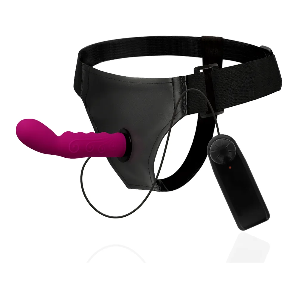 Harnais noir avec tige courbée rose fuchsia vibrante, ceinture ajustable, télécommande filaire et compartiment piles intégré sur fond blanc
