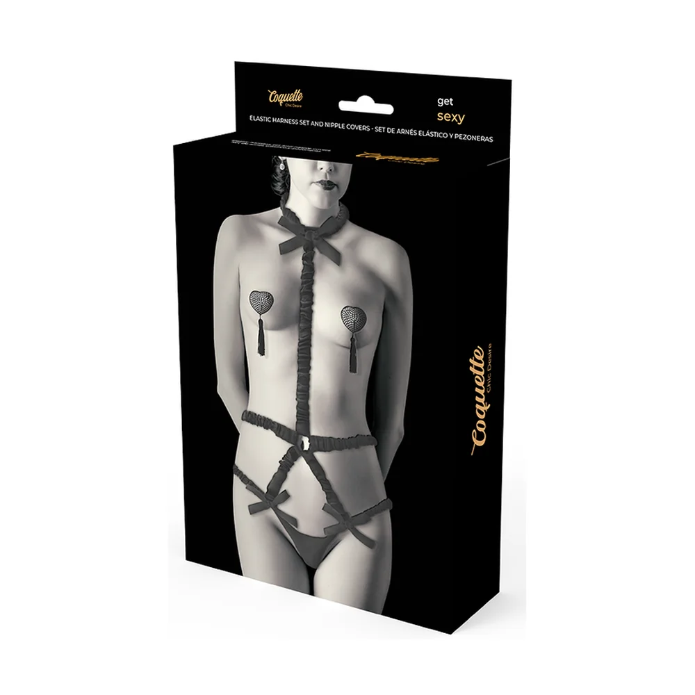 Ensemble lingerie noir avec harnais corset, cache-tétons à chainettes et string assorti, présenté sur mannequin et en boîte de packaging noir