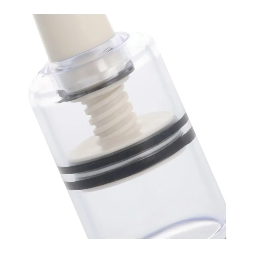 Deux stimulateurs clitoridiens manuels en silicone blanc et cylindre transparent avec ventouse, système à pompage manuel sans pile