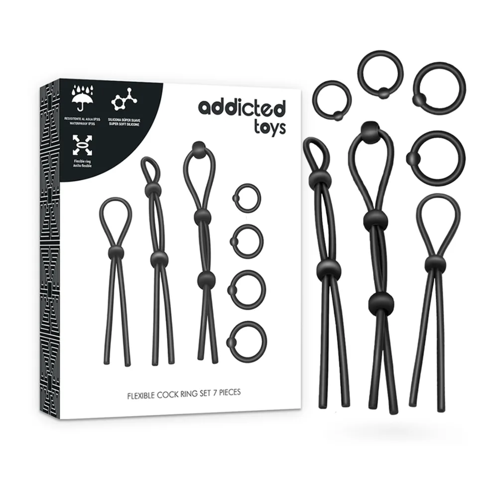 Boîte et contenu d'un ensemble de seven cockrings noirs en silicone : trois cordons flexibles avec perles d'arrêt et quatre anneaux rigides de différents diamètres