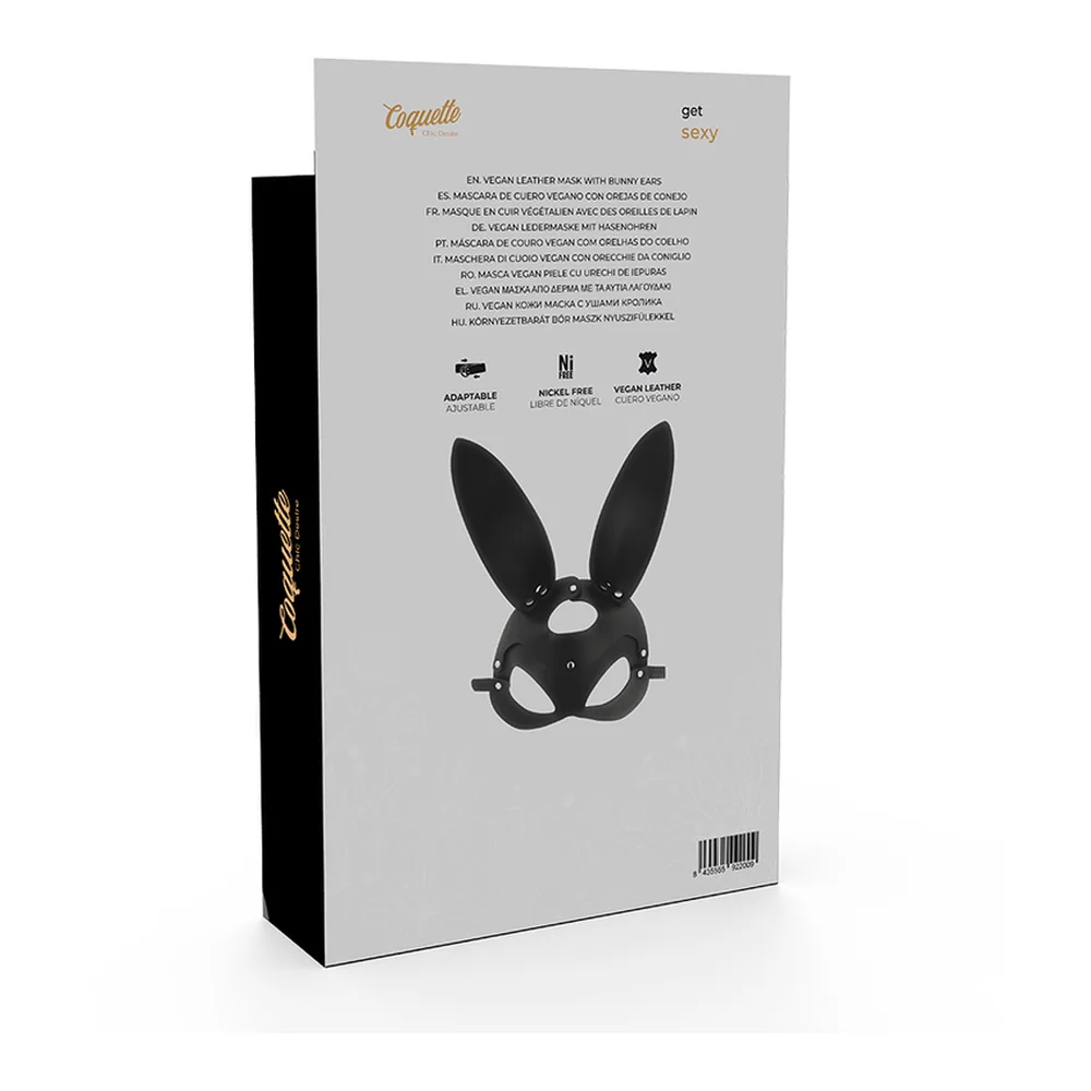 Masque en cuir vegan noir avec longues oreilles dressées, coque moulée aux yeux avec studs, présenté avec son emballage noir et blanc à motif lapin