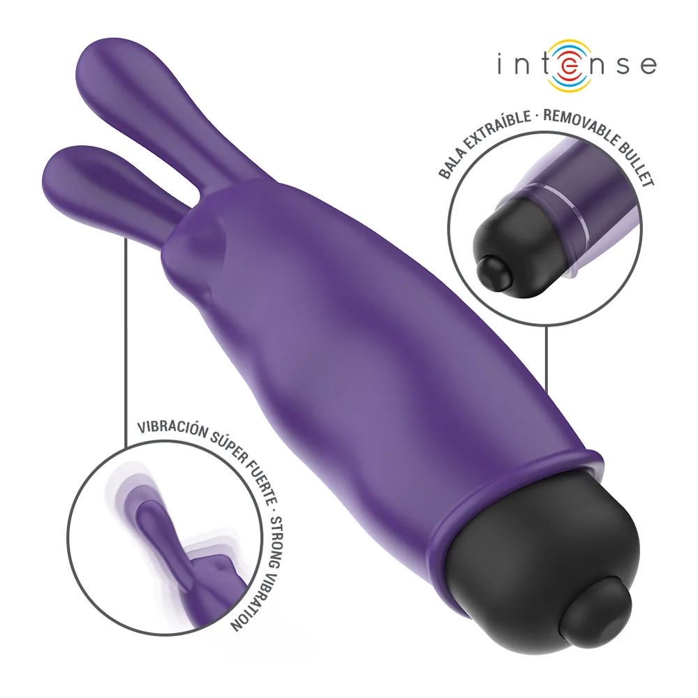 Emballage et bullet vibrant Mystique en silicone violet avec deux oreilles souples et embout noir, présenté de face sur fond blanc