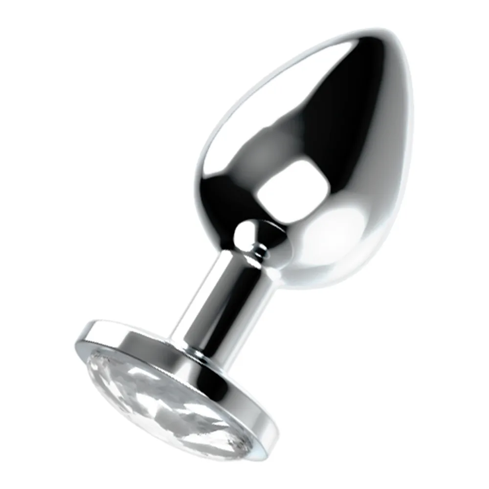 Plug anal en métal brillant, forme de goutte lisse et effilée, base circulaire ornée d'un cristal transparent, sur fond blanc