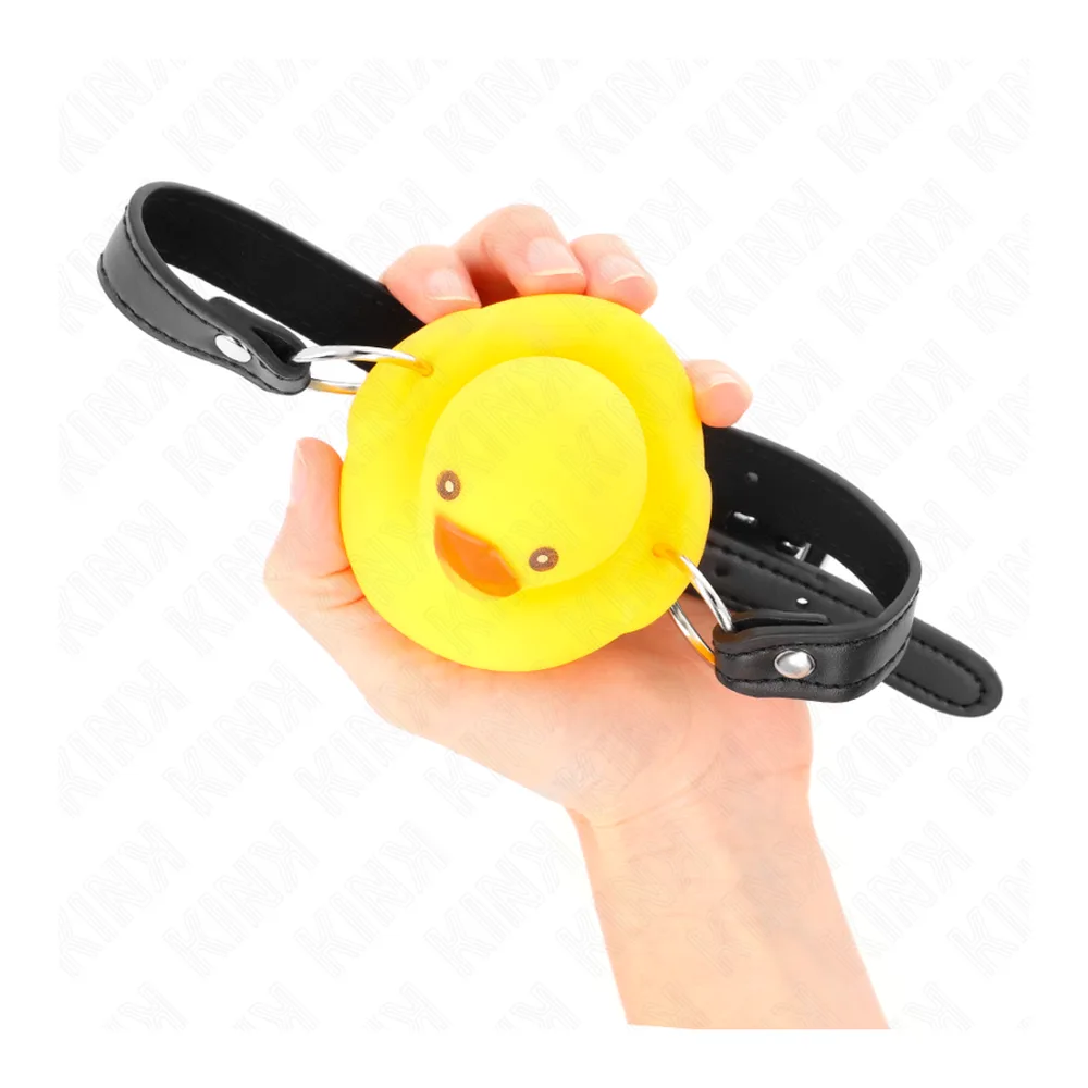 Bâillon en silicone jaune en forme de canard souriant avec bec orange, sangles noires ajustables de chaque côté, fond blanc