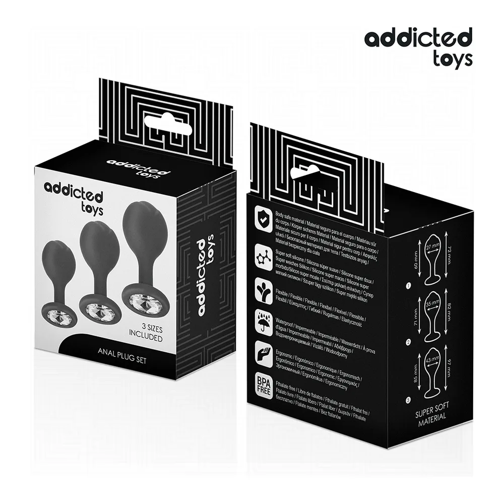 Plug anal noir en silicone tenu dans des mains, montrant la base plate et le diamant serti de strass en détail