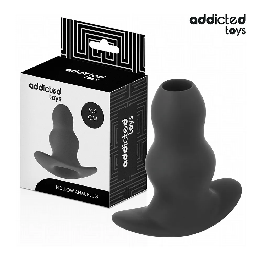 Emballage blanc et noir de plug anal creux Addicted Toys 9,6 cm avec le produit en silicone noir à côté, montrant la forme évasée et le passage creux central