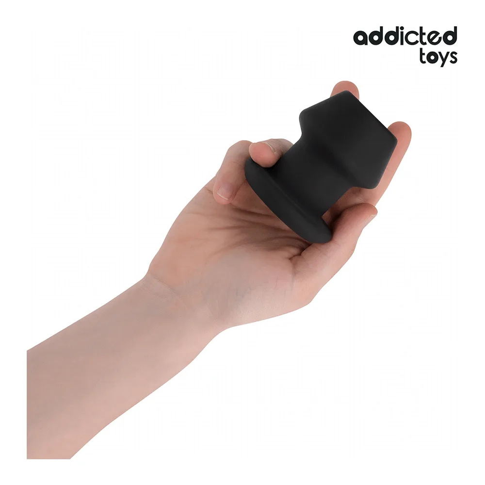 Emballage et plug anal en silicone noir de 7,5 cm avec tunnel creux, design épaulé, marque Addicted Toys