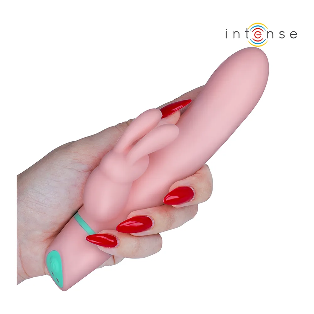 Stimulateur Alvin Rabbit en silicone rose avec deux bras de lapin et bracelet télécommande turquoise, affiché à côté de son emballage blanc de marque Intense