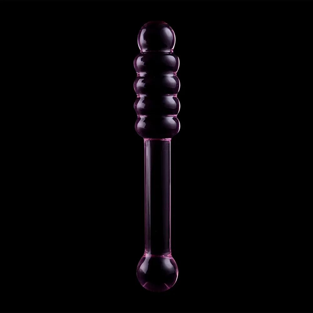 Emballage noir d'un gode en verre transparent avec deux extrémités différentes : perles en relief d'un côté, bille lisse de l'autre, tige cylindrique