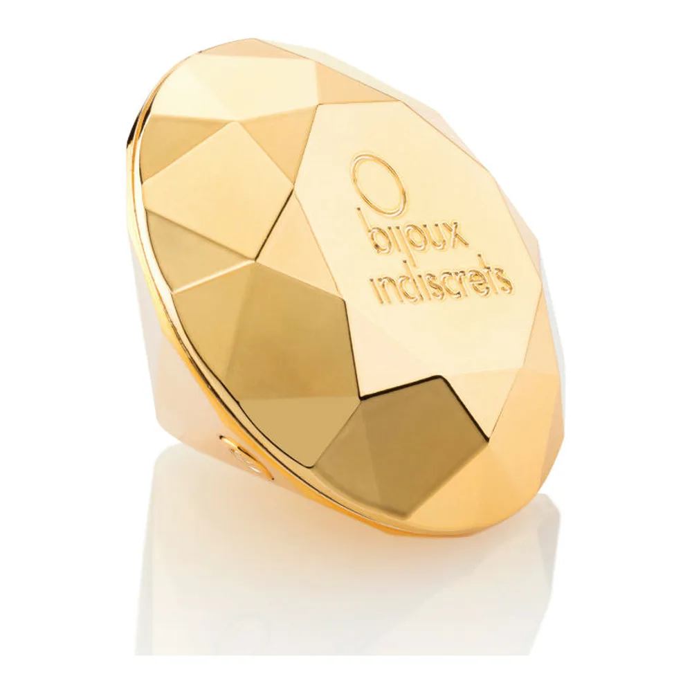 Vibrateur doré en forme de diamant facetté, présenté dans un écrin noir avec coussin noir et inscription dorée « The perfect pleasure »