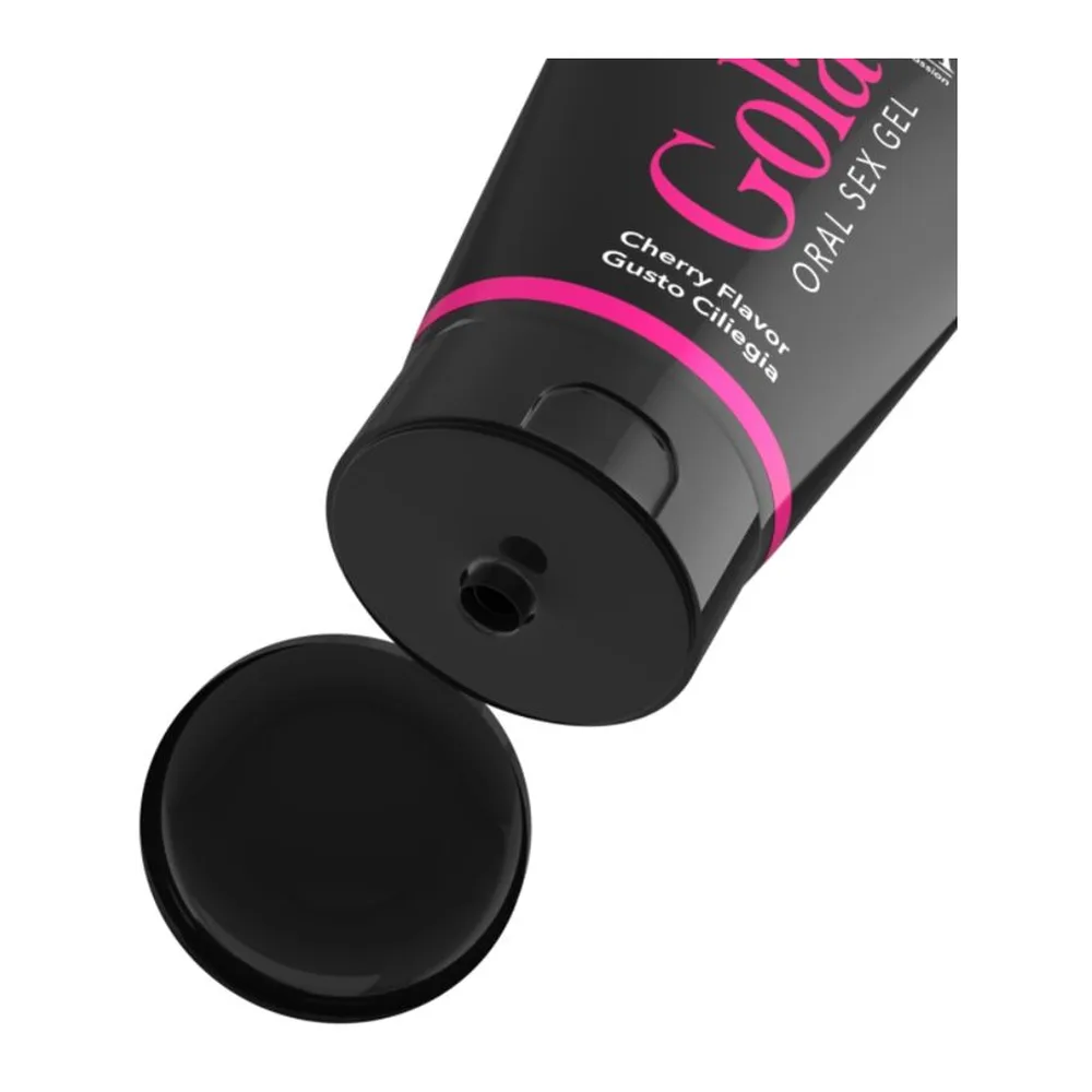 Tube noir avec bande rose vif contenant un gel lubrifiant oral saveur cerise, avec capuchon ouvert et une goutte de gel noir sur fond blanc