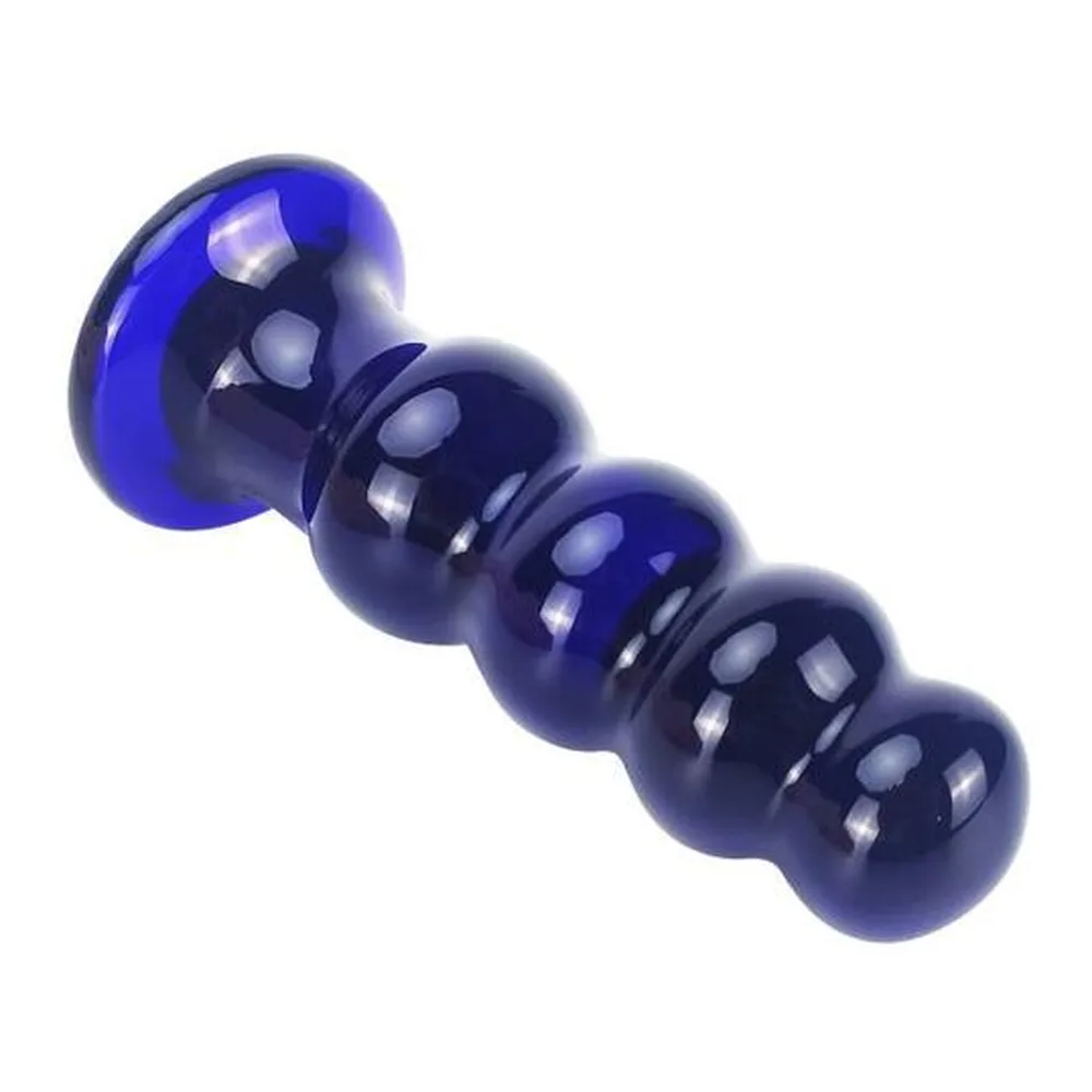 Plug en verre bleu cobalt et noir brillant, à structure graduée de perles rondes empilées sur une base plate, sur fond blanc