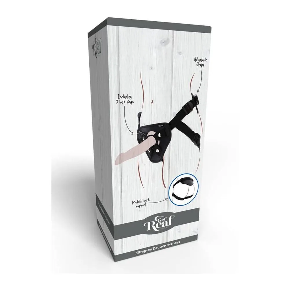 Harnais strap-on noir en tissu rembourré avec quatre rivets métalliques, deux anneaux de fixation en métal, lanières ajustables et branding TOYJOY, présenté à plat sur fond blanc