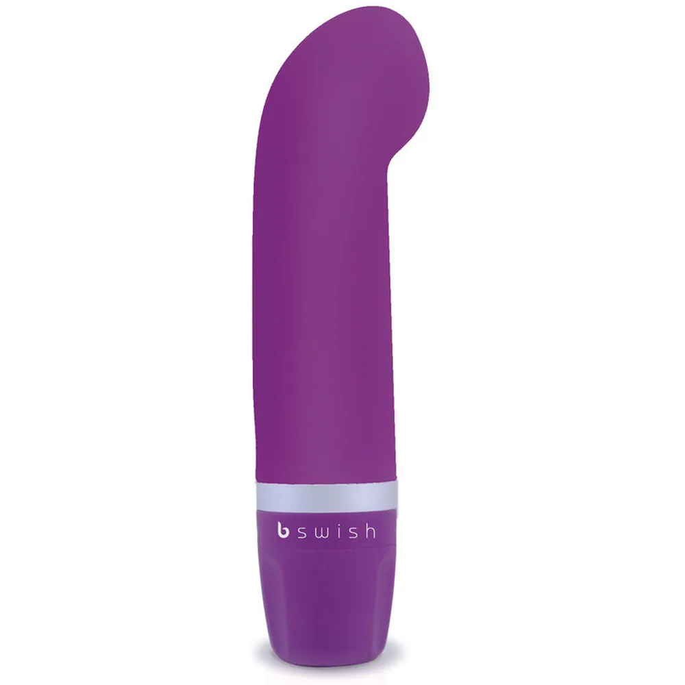 Emballage du stimulateur clitoridien Bcute Classic Curve par B Swish, boîte blanche et rose avec illustration du produit violet courbe et ses caractéristiques listées