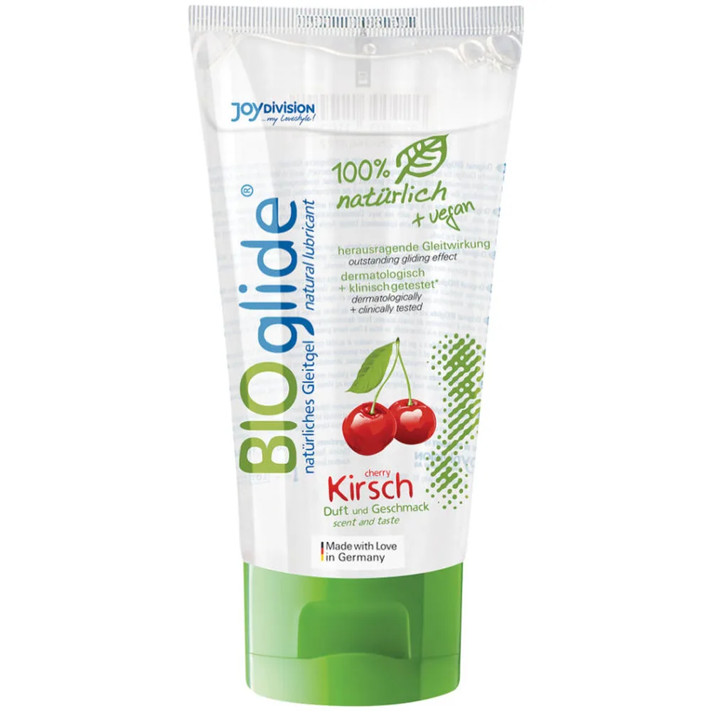 Tube de lubrifiant comestible Bioglide à saveur de cerise, emballage blanc et vert avec feuille et cerises rouges, étiquette 100% naturel + vegan