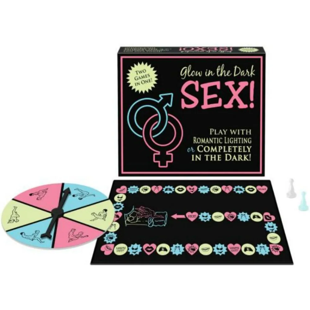 Boîte et contenu du jeu Brille dans le Noir Sexe : plateau luminescent, roue des couleurs rose et bleu, pions phosphorescents, et jetons d'émoticônes sur fond noir