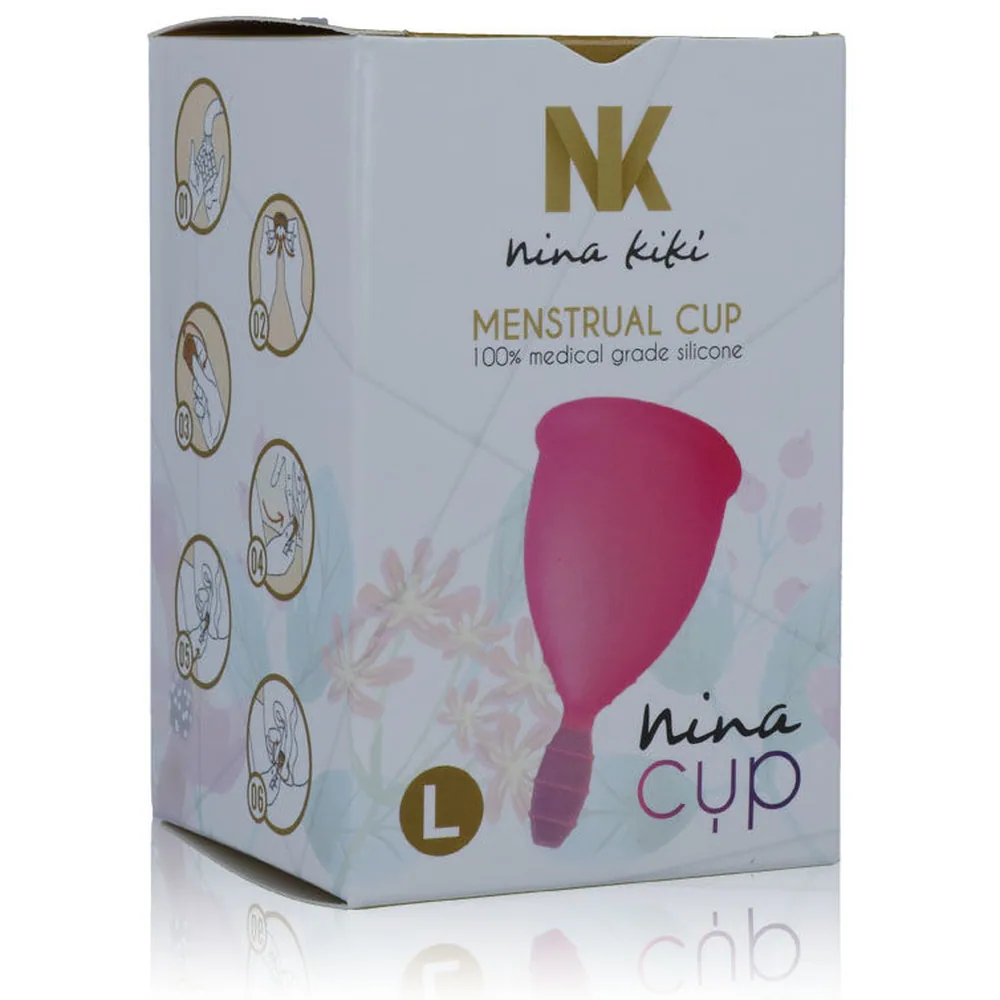 Coupe menstruelle Nina Cup en silicone rose vif, taille L, avec son emballage blanc et or, sachet de rangement coloré, et notice d'utilisation multilingue en français
