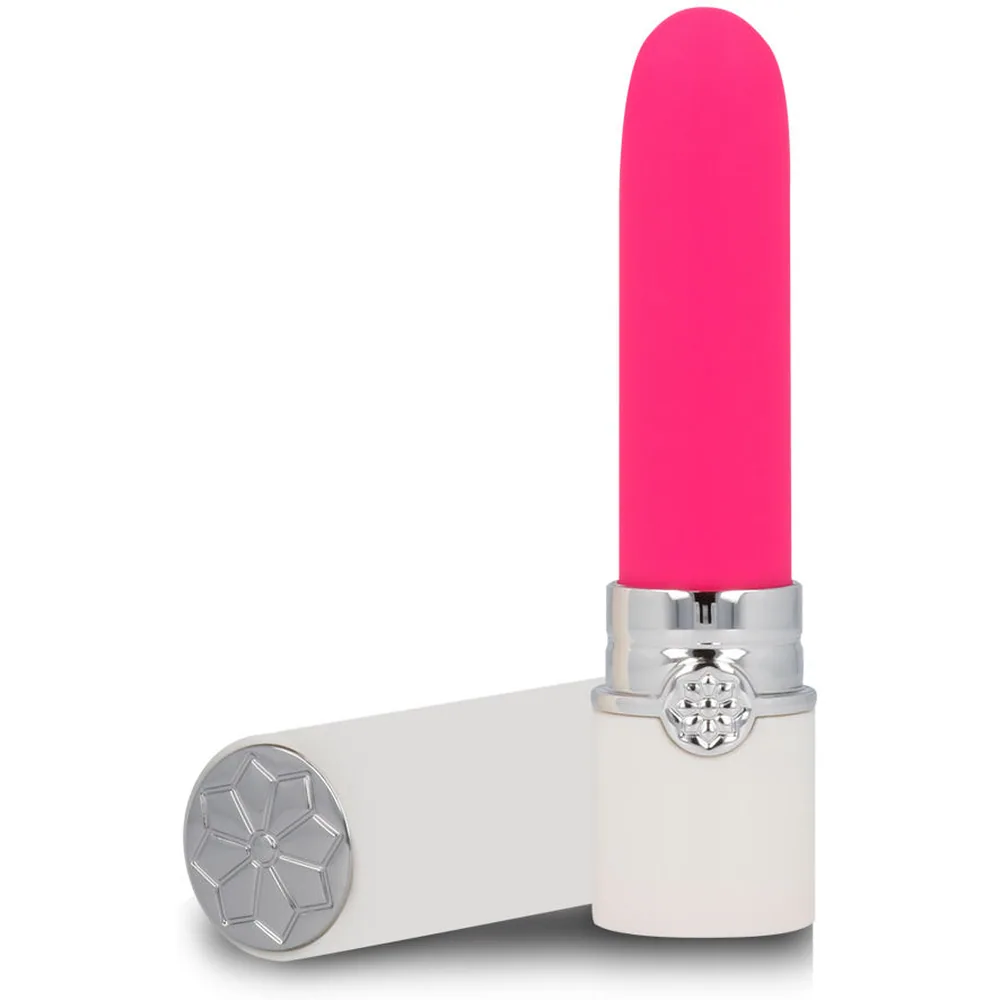 Vibromasseur en forme de rouge à lèvres rose vif avec corps blanc et embout argenté orné d'un motif géométrique floral