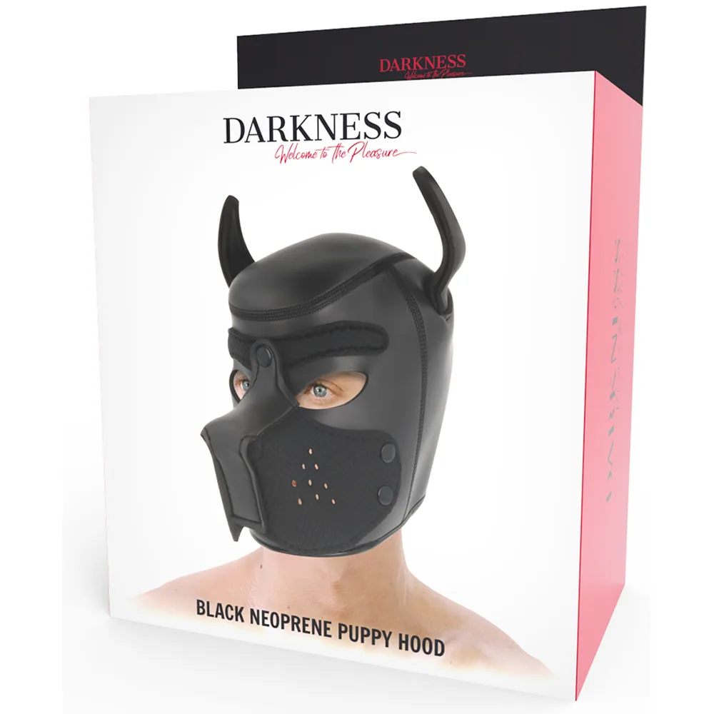 Masque chien en néoprène noir avec cornes, museau amovible et respiration ajourée, présenté à côté de son emballage rose et noir