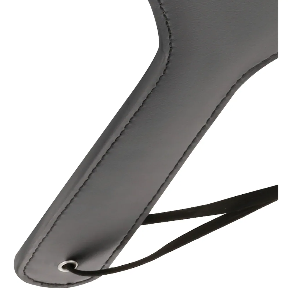 Paddle en silicone gris avec tête en forme de cœur et lanière noire de préhension, vue de profil sur fond blanc