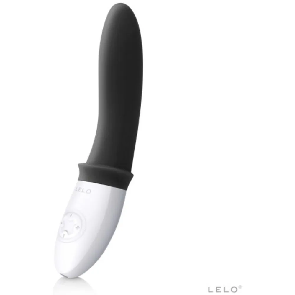 Stimulateur de prostate noir et blanc, forme ergonomique avec commandes tactiles sur le manche blanc, fond gris neutre