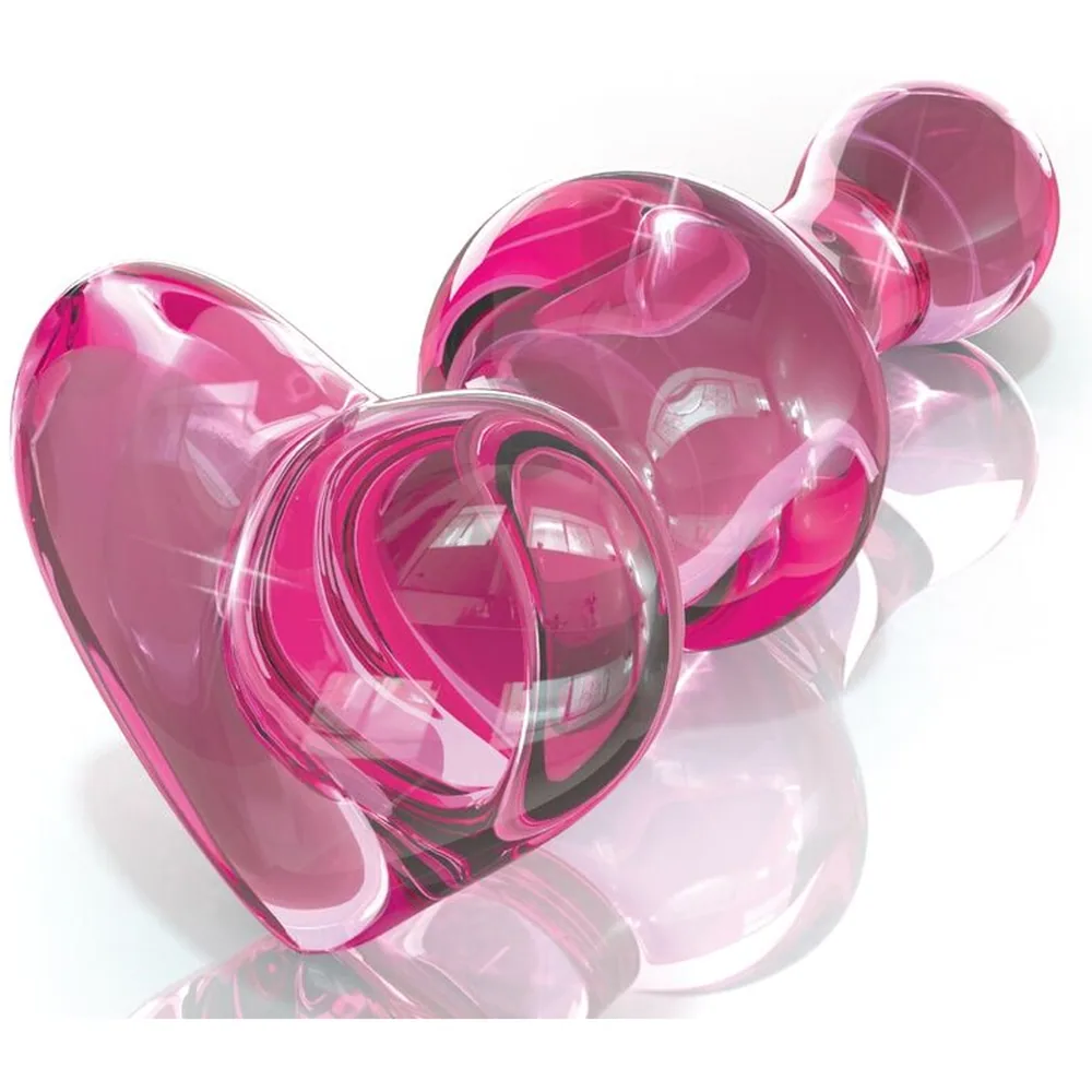 Gode en verre rose clair translucide, forme bulbeuse large avec poignée arrondie, présenté sur fond blanc