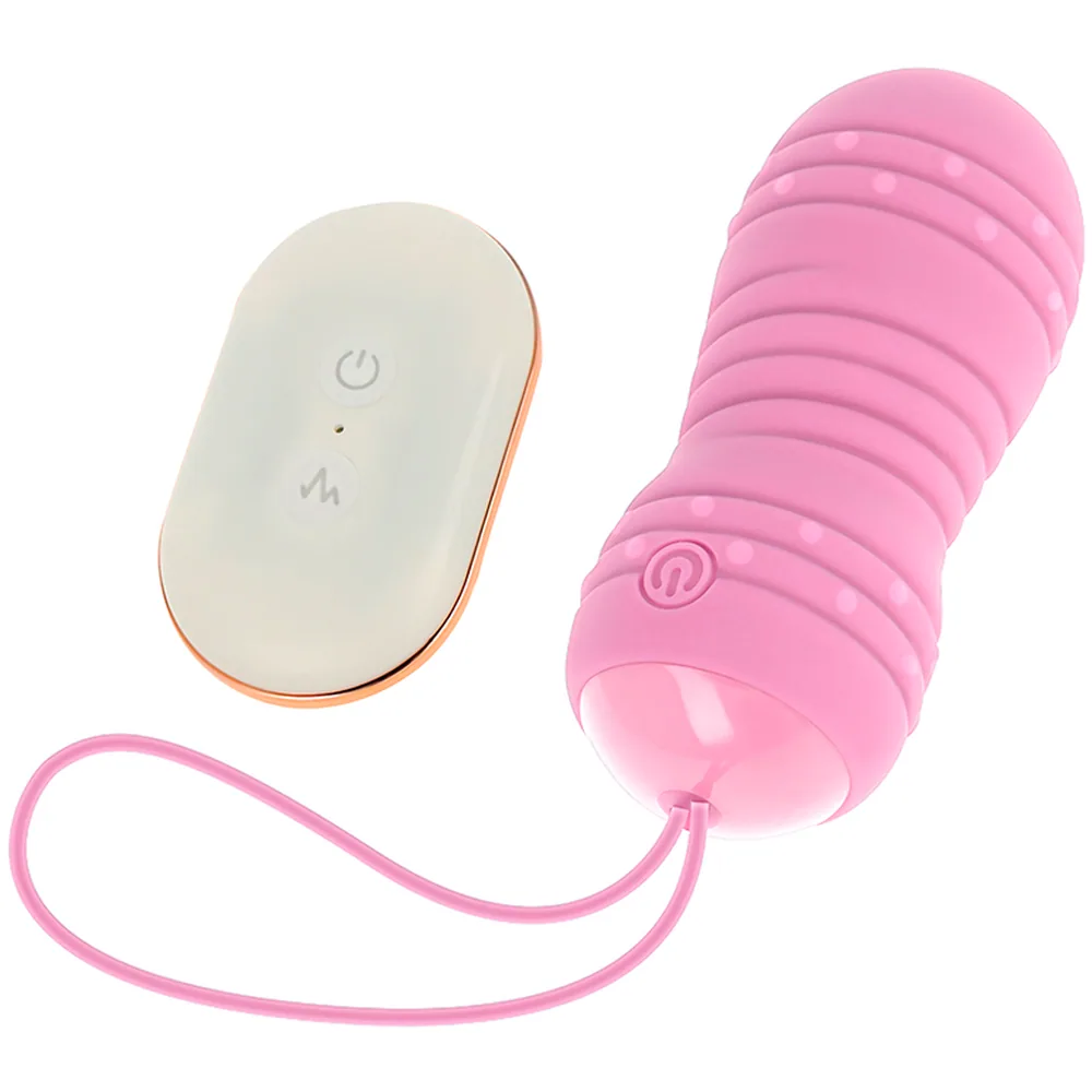 Œuf rose pâle à rainures avec perles internes, connecté par cordon rose à une télécommande blanche et beige affichant bouton marche et symboles de contrôle