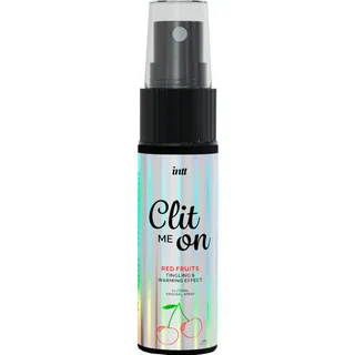 Spray Clit me on aux fruits rouges avec flacon transparent et noir, bague pulvérisatrice, sur emballage multicolore à rayures avec illustration de cerises