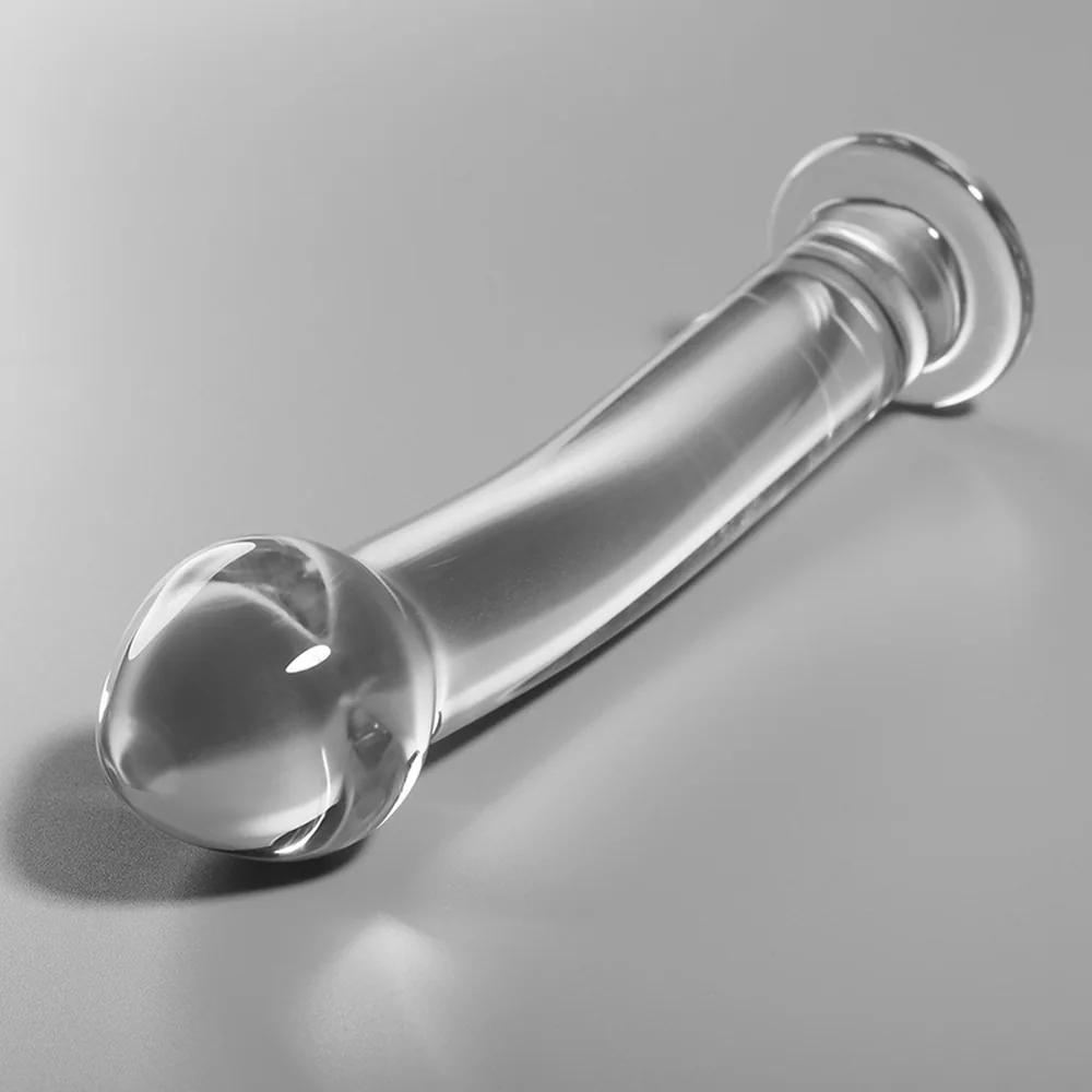 Gode en verre transparent avec extrémité bulbeuse arrondie et corps légèrement incurvé, présenté seul et dans son emballage noir