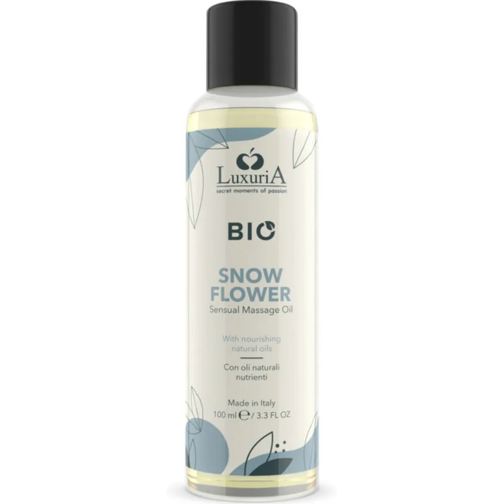 Flacon de 100 ml d'huile de massage biologique Snow Flower Luxuria, liquide clair ambré avec étiquette blanche et bleu, bouchon noir, formule à base d'huiles naturelles nourissantes