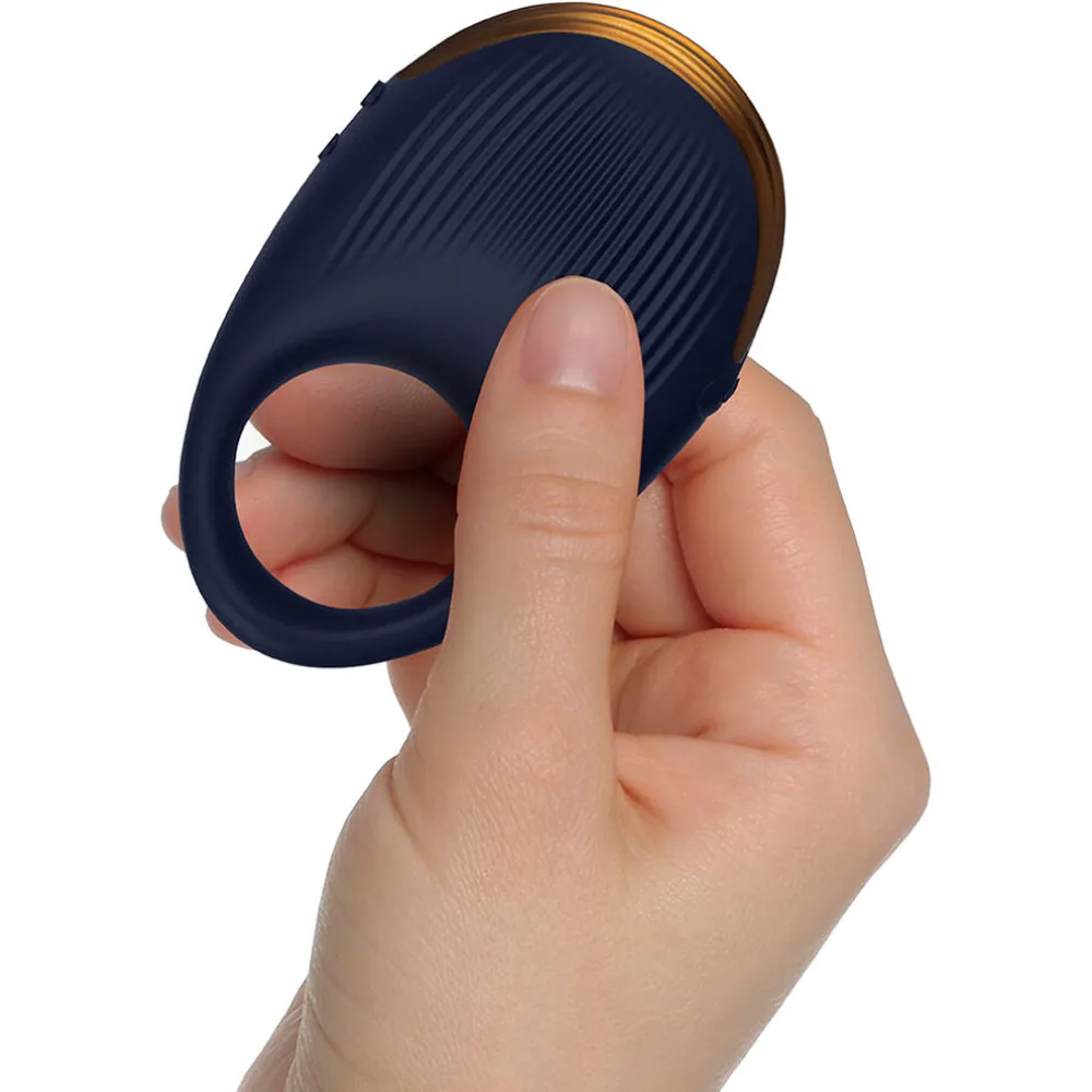 Anneau vibrateur en silicone bleu marine avec détails nervurés, bord supérieur en bois naturel clair, ouverture centrale visible sur fond blanc