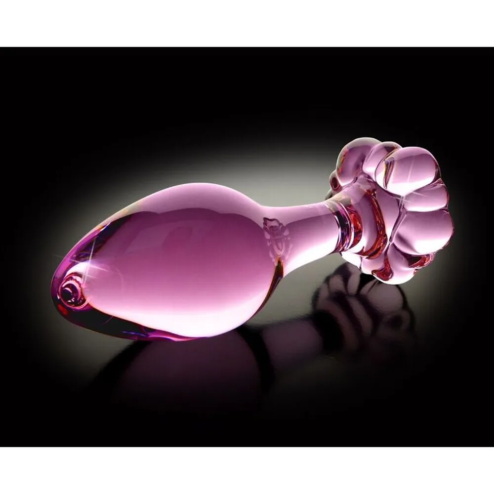 Plug anal en verre rose avec tête bulbée nervurée et anneau de retrait en forme de boule, brillant, sur fond blanc